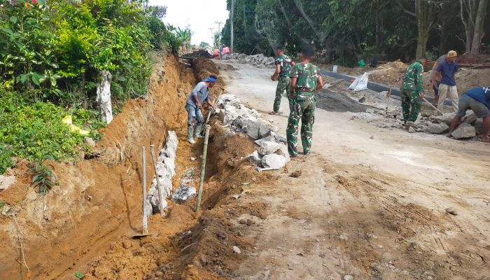 Satgas TMMD ke-127 Lanjutkan Penyusunan Batu Drainase di Nagori Bahapal